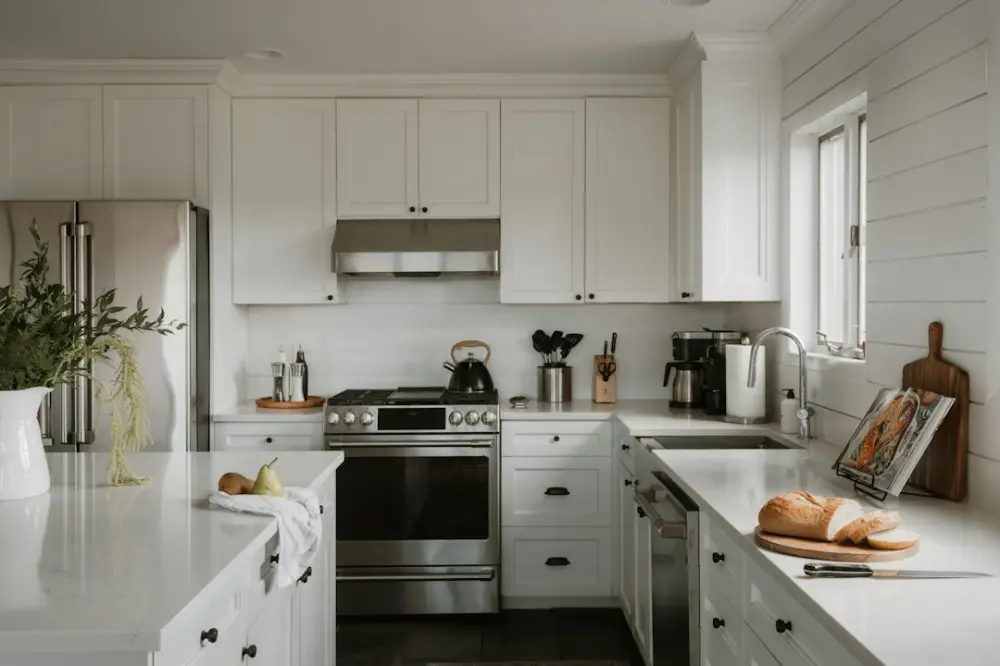 Bright, modern kitchen with white cabinets and stainless steel appliances, illustrating flexible planning around household